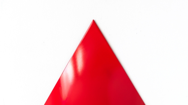A red pylon against a white background